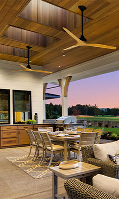 Evening photo of an illuminated outdoor kitchen setup ready for a BBQ