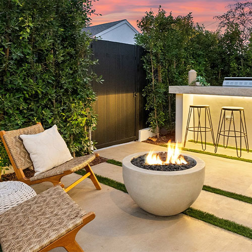 Modern backyard patio with custom-built grilling station and bar seating